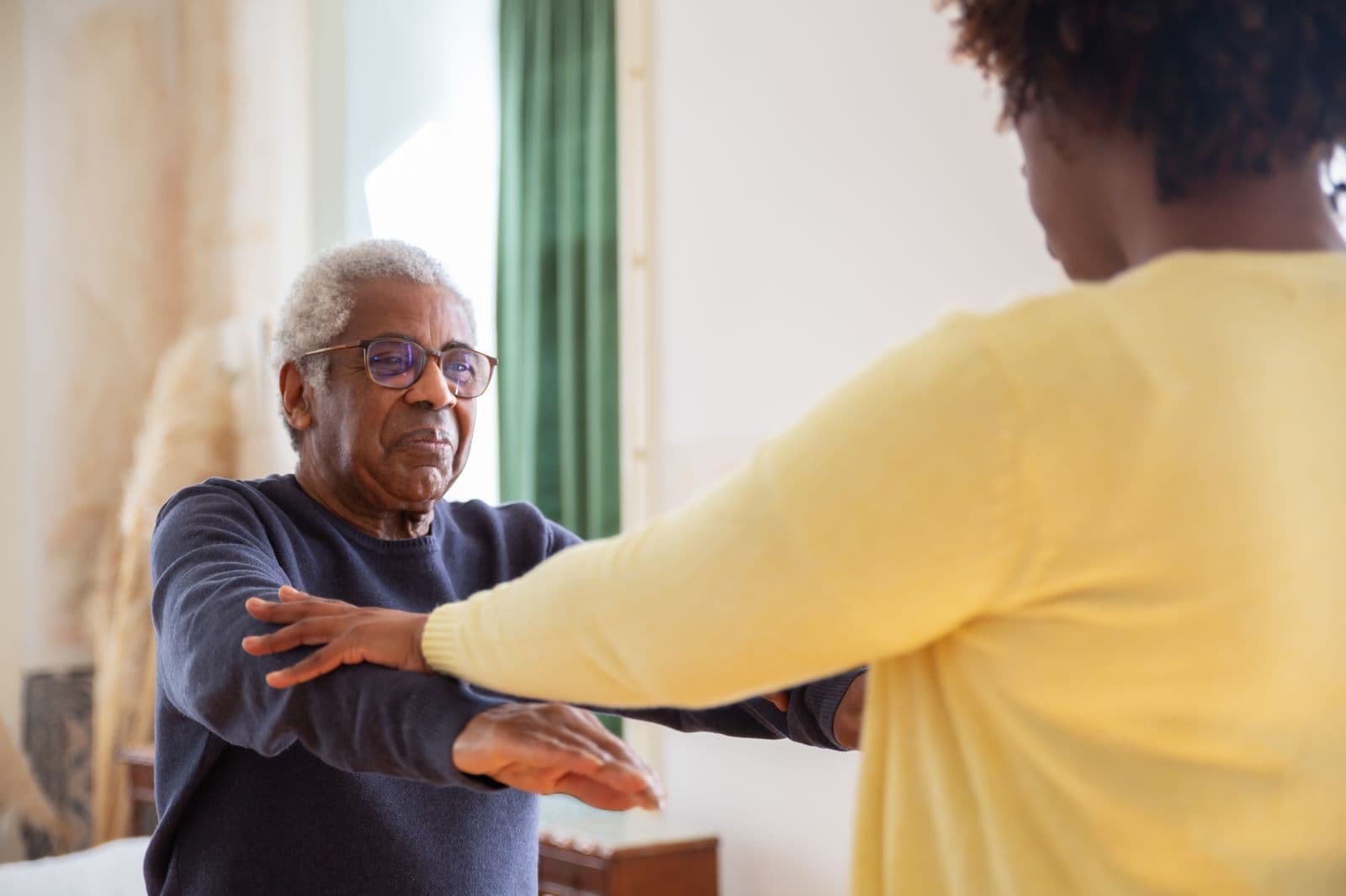 Steady one-to-one support helping someone move with confidence at home